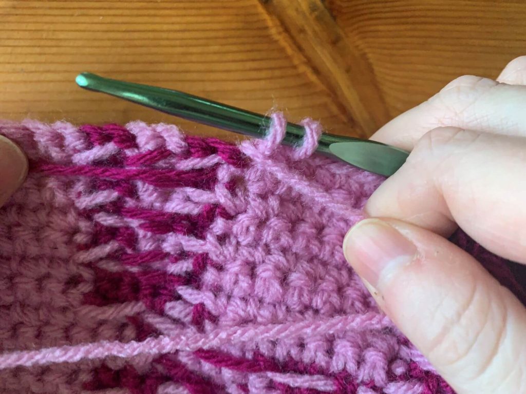 When switching colors in crochet, hold your working yarn towards the back of the work 